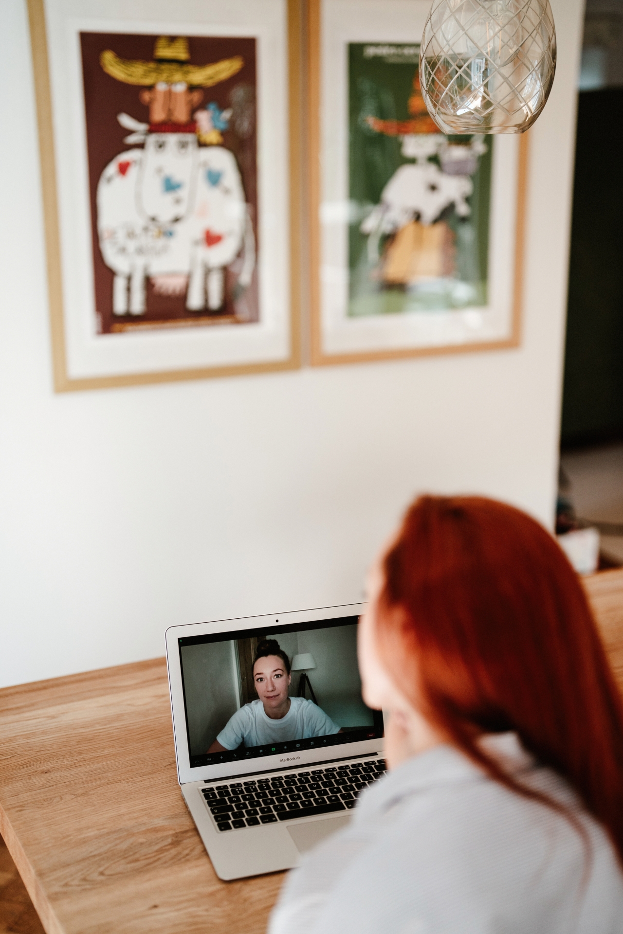 A dynamic virtual consultation between Dr. Amy-Jo, a coach, and her client shows a vibrant interaction on the computer screen.