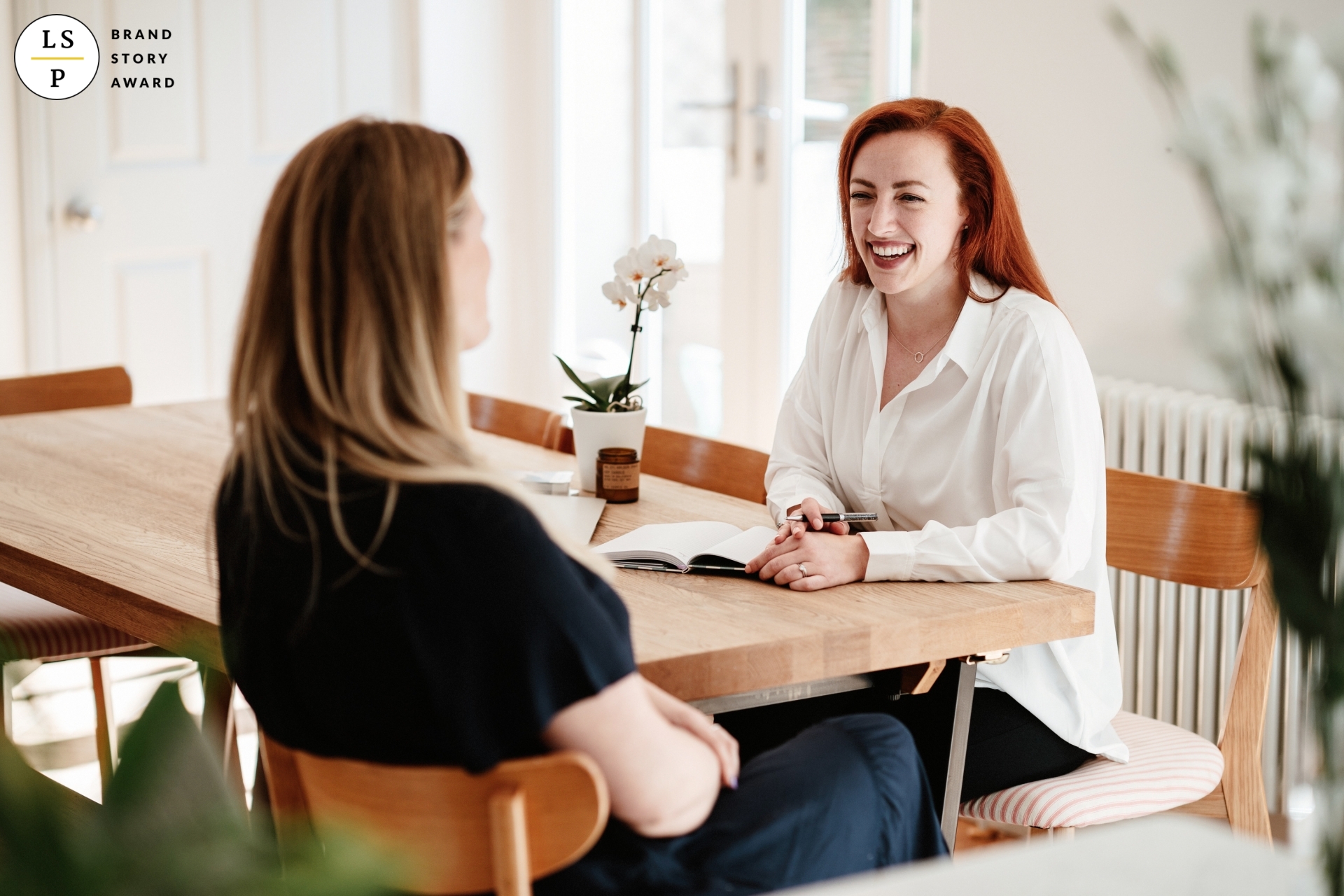 Dr. Amy-Jo, a Burnout Coach, supports a client in a tranquil setting as they discuss strategies for managing occupational stress.