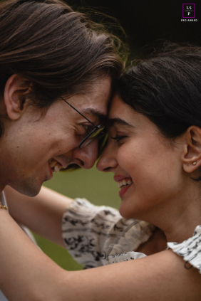 In Toronto, this close embrace captures two people completely absorbed in each other’s laughter and presence. The tight framing and soft focus remove every distraction, allowing the shared expressions and gentle touch to carry the photograph beautifully.
