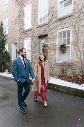Walking through Cedarburg together, this couple shares an easy laugh that makes the winter street feel instantly warmer. The natural movement and relaxed expressions give the photograph charm, connection, and effortless romantic energy.
