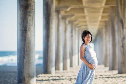 California happy Mom-to-be during a maternity session under the pier