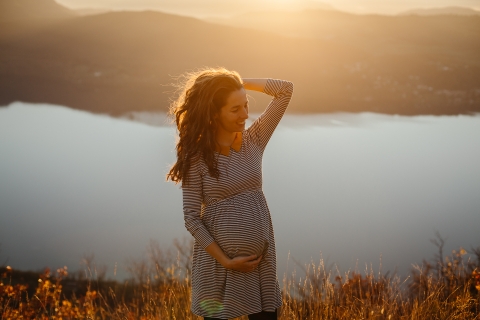 Auvergne-Rhone-Alpes Creative Lifestyle pregnant woman portrait by the water at sunset