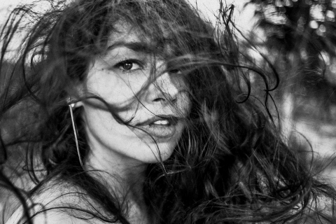 Alagoas Creative Lifestyle Portrait image capturing wind-blown hair as it combs a young woman's hair