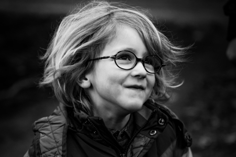 East Flanders boy with glasses poses for a lifestyle portrait shown in black and white