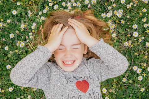 Cote-d'Or girl poses for a lifestyle photoshoot laying on the ground with flowers