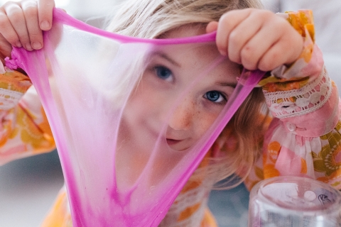 London young girl poses for a Lifestyle Portrait Session as she is Looking through the slime