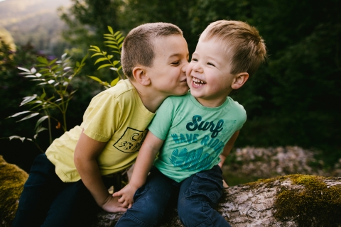 This is a lifestyle image of a boy doing silly things with his brother in Bourgogne-Franche-Comte