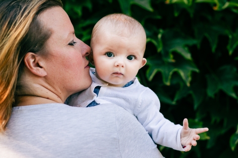 A lifestyle family image in Bourgogne Franche Comte showing a Dijon mom Smelling baby