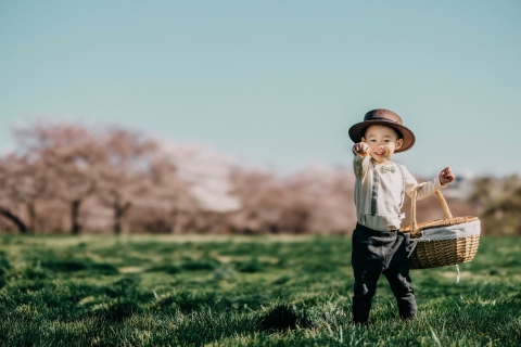 New York Solo Lifestyle Portrait Session of a boy sending love with cherry blossoms