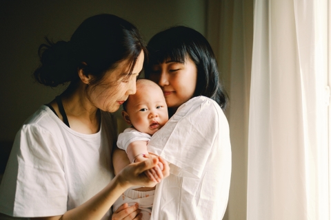 This heartwarming lifestyle portrait captures three generations - a mother, grandmother, and baby - embracing in Redmond, WA