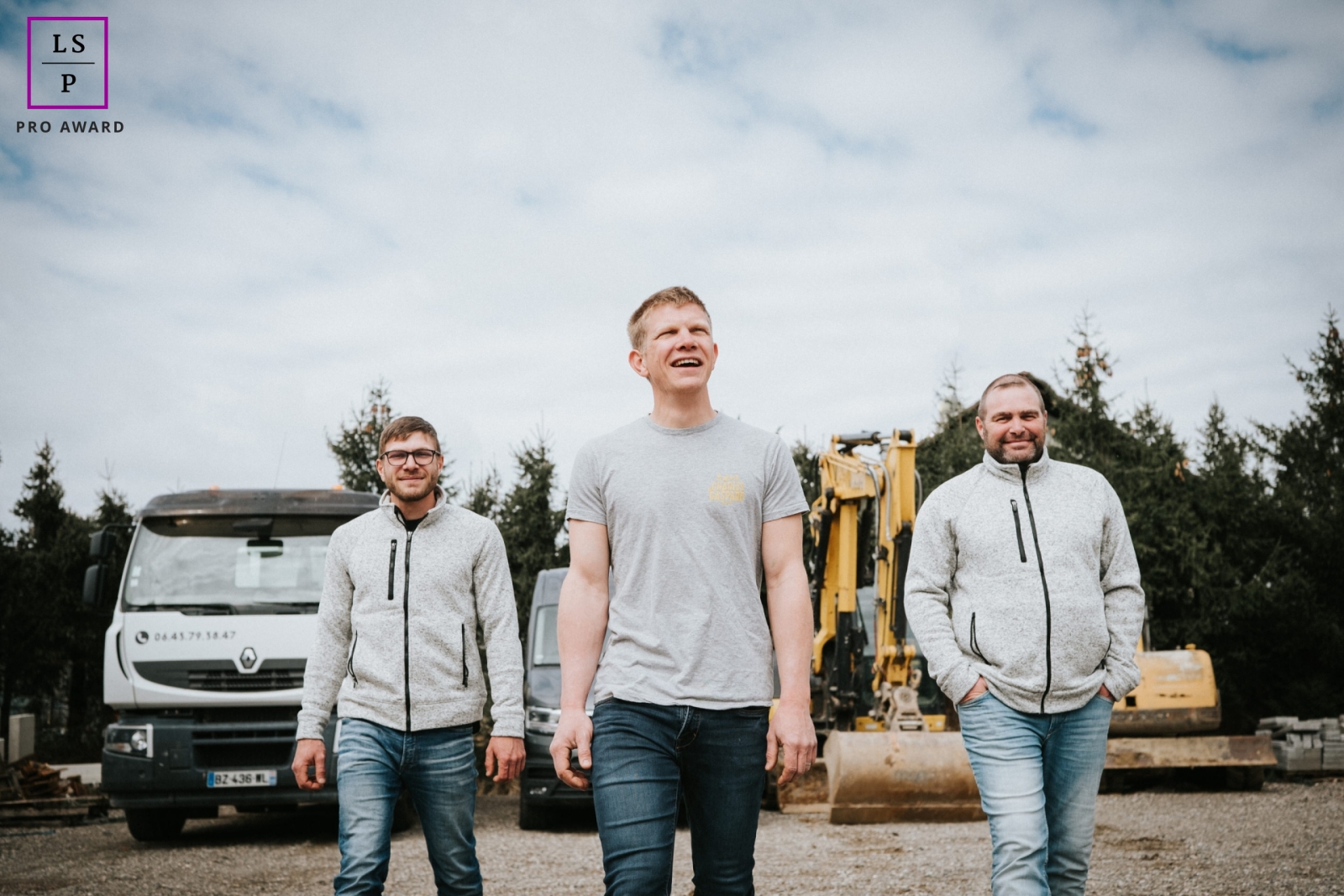 In the region of Alsace, France, the team from a leading Earth Works Company strides confidently towards the camera, leaving heavy construction equipment behind.