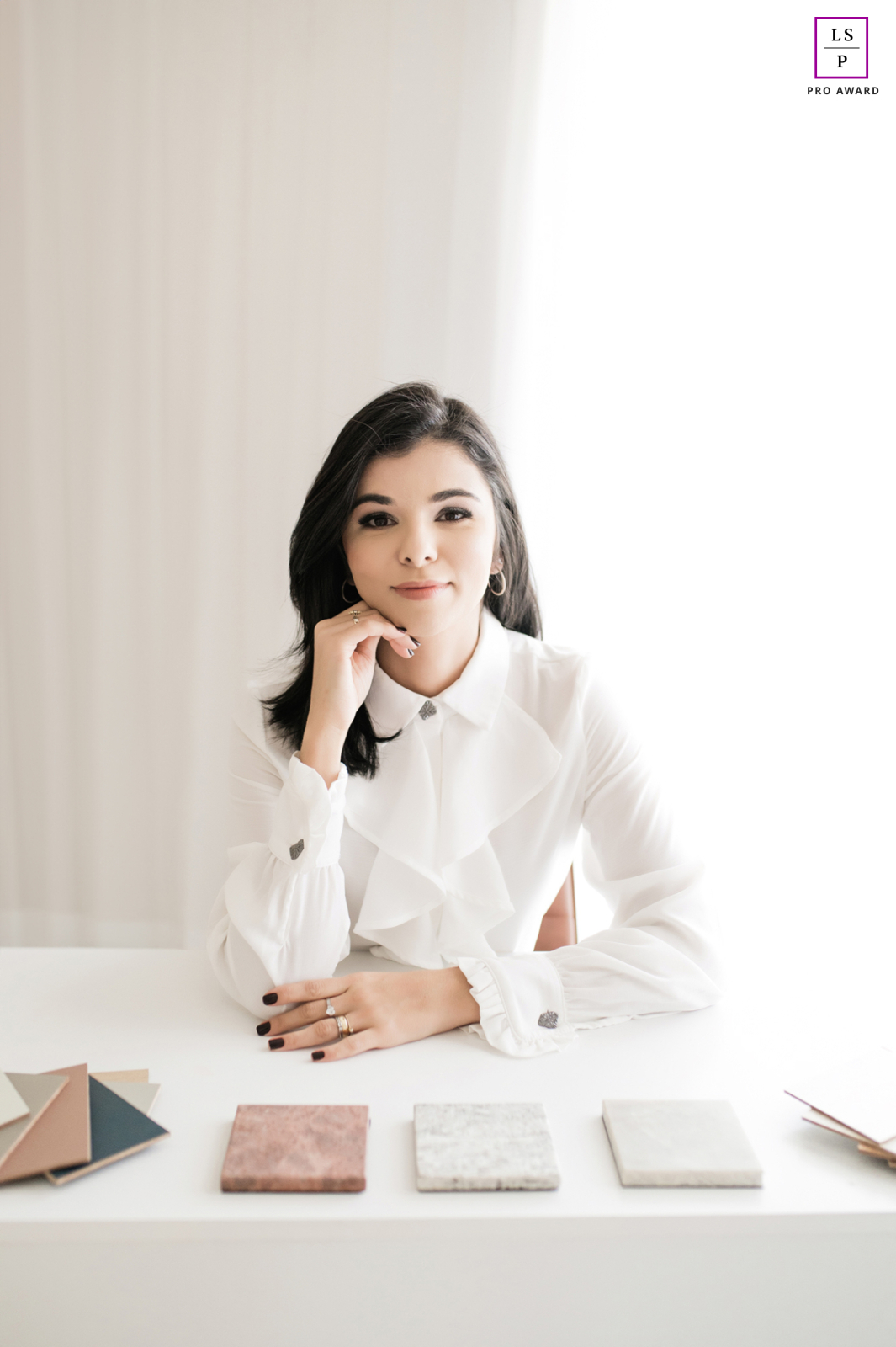 Luciana, an architect from Brazil. In this photo, she shows off her creative side surrounded by color samples. Her workspace screams minimalist perfection in Macae, Brazil.