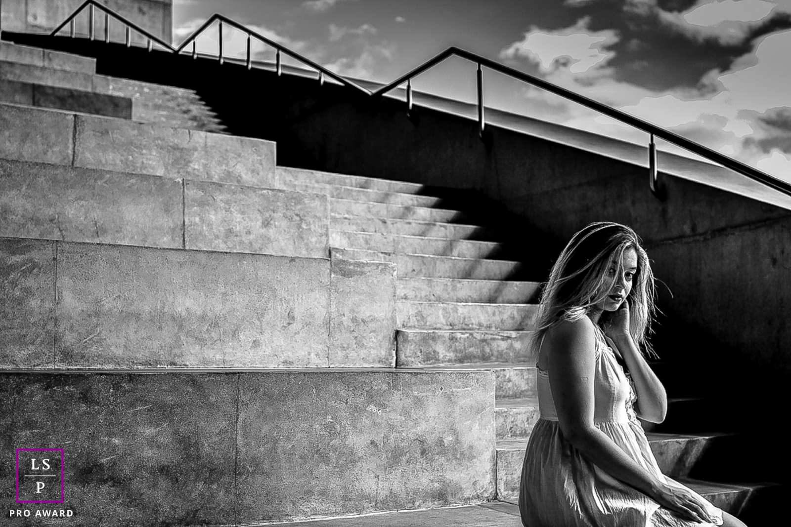 A young woman showcasing geometric beauty while sitting on stone benches in Rio de Janeiro
