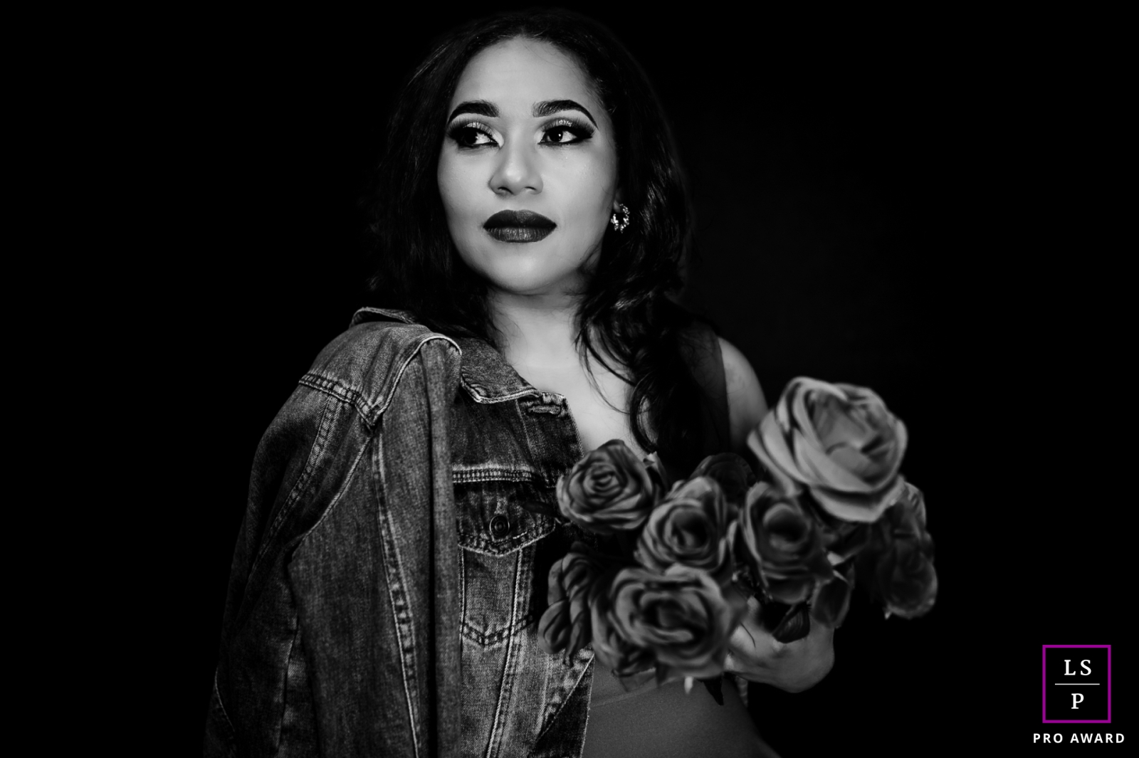 In Pigeon Forge, Tennessee, a captivating black and white lifestyle portrait captures the elegance of a woman gracefully clutching a bouquet of flowers