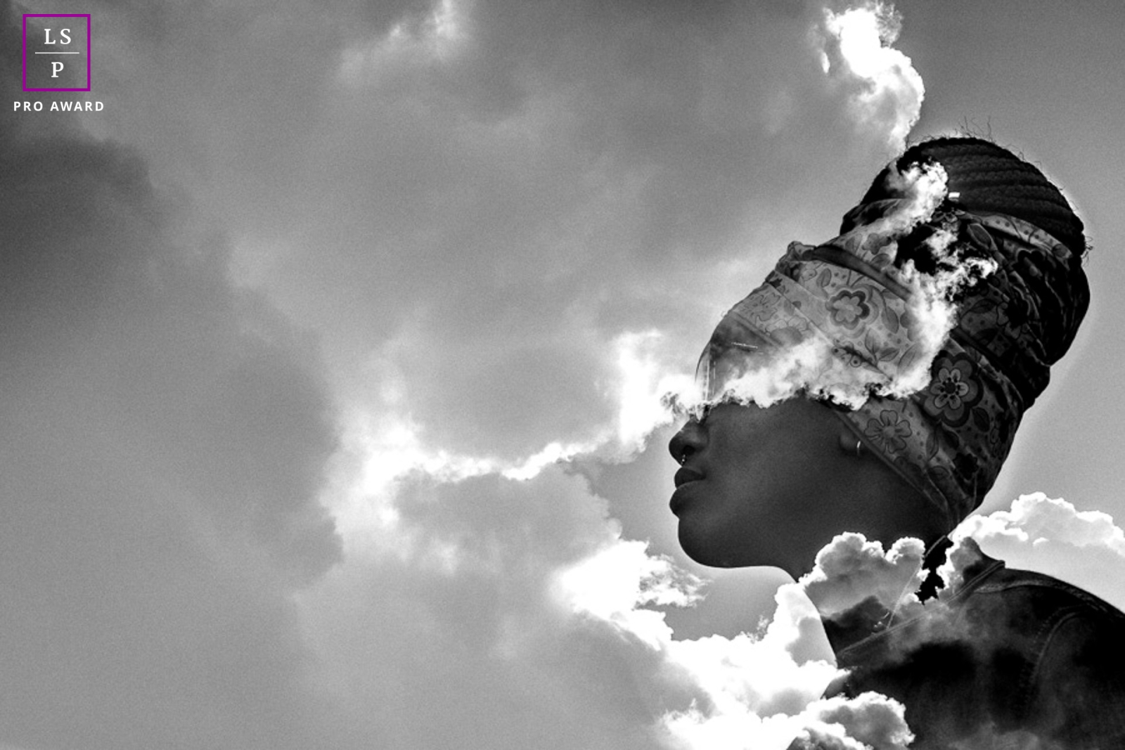 An image captures the essence of Rio de Janeiro's culture with this captivating portrait. Against the backdrop of clouds, a poised woman dons a traditional headdress, revealing the depths of her thoughts in this introspective shot.