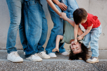 In Paris, the family dissolves into laughter as the older sister hangs upside down between her parents while her younger brother joins the chaos. Cropped framing and playful movement turn this family portrait into something wonderfully energetic.