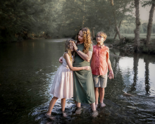 A mother shares a tender session with her two children while standing together in a peaceful stream in Woodstock, Vermont.
