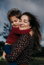 A young boy wraps his arms around his mother as she holds him close during a tender session in San Leandro, California.