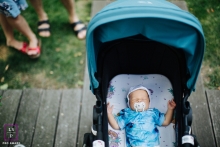 Family Photographer in Warsaw Mazowieckie | Lifestyle Image contains: infant, baby, stroller, pacifier, deck, yard