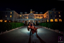 A lifestyle couple picture taken at the Stanley Hotel during a photography session with a lit Dance dip at night
