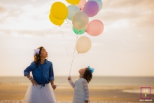 Experience the innocence and joy of two little sisters at the beach, captured in a delightful lifestyle portrait by a talented photographer at Mayflower Beach in Dennis, Massachusetts