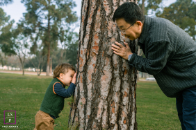A loving grandfather and his grandson are playing hide-and-seek together on a sunny day in Long Beach, Southern California.
