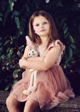 At Stanley Park in Blackpool, a young girl clutches her teddy bear and looks at the camera, capturing the sentiment, "My Teddy goes everywhere."