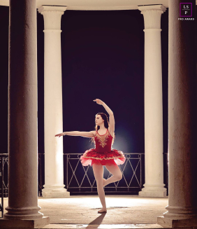 At Blackpool’s Stanley Park, a young dancer strikes a pose inside an old-world structure, dramatically backlit by the photographer’s lighting.