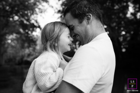A Father's Love: Shared Smiles And Tender Foreheads In French Haute-Garonne In Haute-Garonne, France, a dad holds his small toddler girl as they press their foreheads together, both smiling in a display of father-daughter closeness.