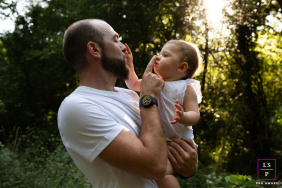French Father and Daughter Share Gentle Nose-touch Mirroring Connection In Haute-Garonne, France, a dad holds his small toddler girl as they gently touch each other's noses, creating a mirror-like connection.