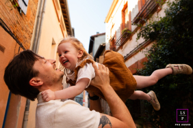 Haute-Garonne Father Lifts Toddler Daughter Skyward: A Playful, Joyful Connection In Haute-Garonne, France, a dad lifts his small toddler girl into the air, capturing a playful, soaring scene of connection.