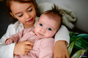 Isère, France: A Baby's Direct Gaze Captures "Ma Toute Petite Sœur" In Isère, France, a baby gazes directly at the camera, capturing the essence of “ma toute petite sœur.”