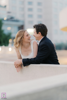 In Madison, Wisconsin, a couple in formal wear poses on a rooftop, their connection radiating against the backdrop of the bustling city.