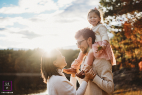 Sunny Fall Hike: A Family of Three at a Boston Lakeside Park Family of three enjoys a sunny fall hike together at a Boston lakeside park.