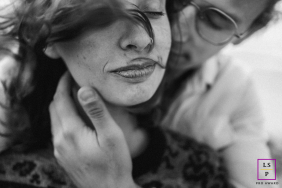 A couple embraces lovingly, captured in an intimate and tender lifestyle portrait.