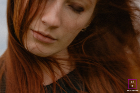 Lifestyle photo: Indre, a woman with wind-blown hair, looking off-camera.