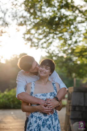 Atlanta engagement session at Piedmont Park, candidly capturing an intimate, sunlit embrace full of love and joy.