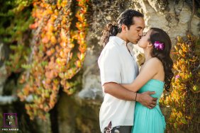 Santa Cruz couple kissing outdoors, beautiful natural light illuminating their loving portrait.