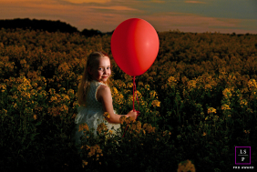 Does Bert the balloon have a destination in mind, or is he just Chloe's silent partner in this twilight field? The crimson orb provides a stunning, graphic punch against the textures.