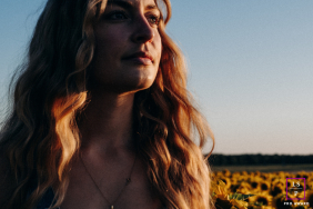 In Châteauroux, warm evening light brushes across this woman’s face as sunflowers stretch endlessly behind her. The close framing and golden tones create a portrait that feels reflective, natural, and quietly connected to the surrounding landscape.