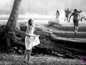 Young Girl Looks Back As Children Run Through Woodstock Vermont A young girl looks back toward the camera while other children run playfully into the distance during an outing in Woodstock, Vermont.