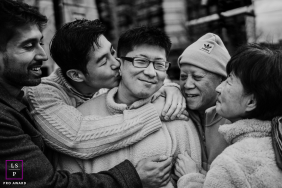 Family Shares Kisses And Embraces During Heartfelt Goodbye In Boston A family gathers in a close embrace, sharing kisses, smiles and emotion during a heartfelt goodbye together in Boston.