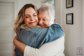 Mother And Adult Daughter Share Joyful Family Hug Together In Boston A mother and her adult daughter embrace tightly with joyful smiles, sharing a warm and affectionate family hug together in Boston.