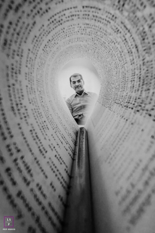Black and white business portrait of a book author and professor from Massachusetts Institute of Technology, resembling a tunnel within folded book pages