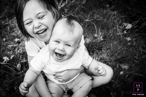 French Lifestyle Photographer created this artistic portrait with A young sibling who laughs