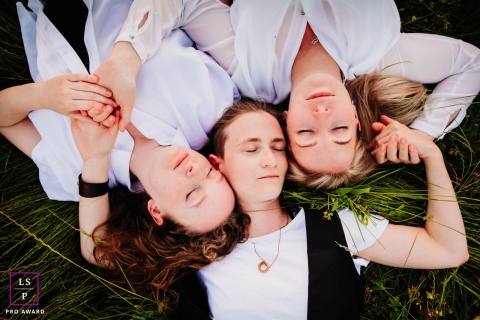 Auvergne-Rhone-Alpes family pose for a lifestyle photograph of these triplet sisters