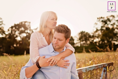 A lifestyle portrait captures the romance of a couple as they embrace against the backdrop of a sunset in the tranquil, rural oasis of Waltrop, NRW, Germany