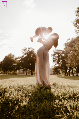Expectant mother in the South of France cherishing the time with her first child, captured in a glowing sunbeam and from a unique low angle.