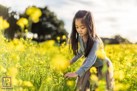 This young girl captures the bright joys of childhood in the sunny fields of Fremont, California.