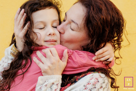 In the city of Paris, a special bond between a mother and her daughter is beautifully captured as they embrace in a sweet kiss and hug. 